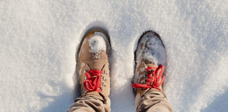 person wearing brown pants and white and red sneakers