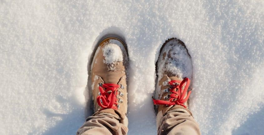 person wearing brown pants and white and red sneakers