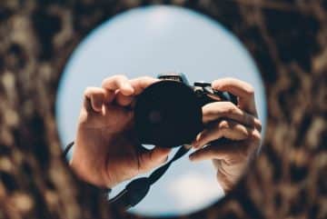 person holding black dslr camera