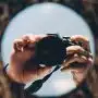 person holding black dslr camera